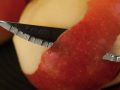 apple being peeled with a knife