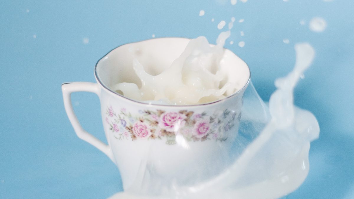 tea cup with soy milk splashing in it