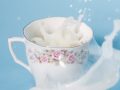 tea cup with soy milk splashing in it