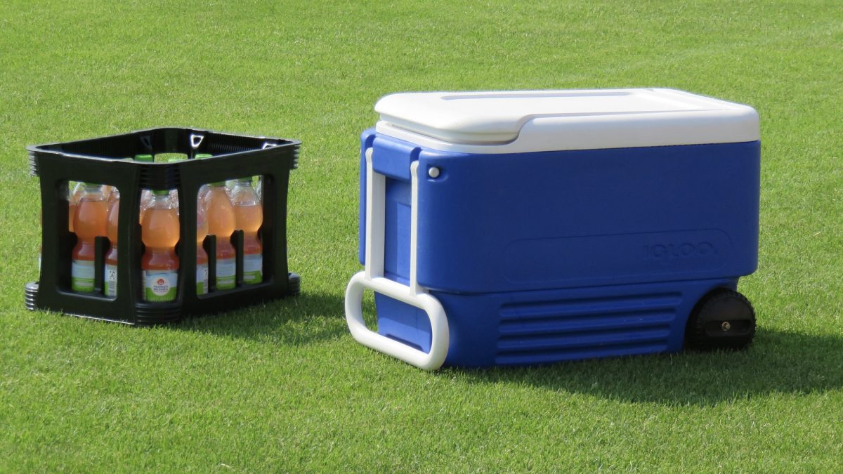 crate of sports drinks next to a cooler box