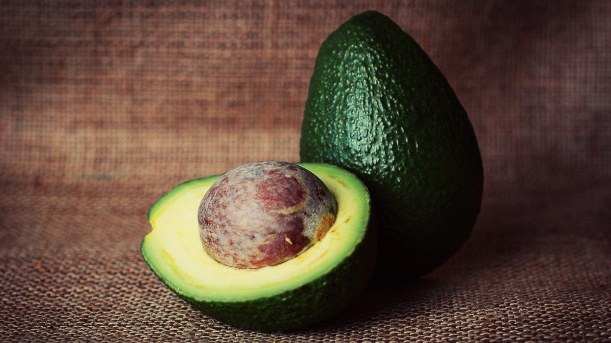 a halved and a whole avocado