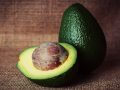 a halved and a whole avocado