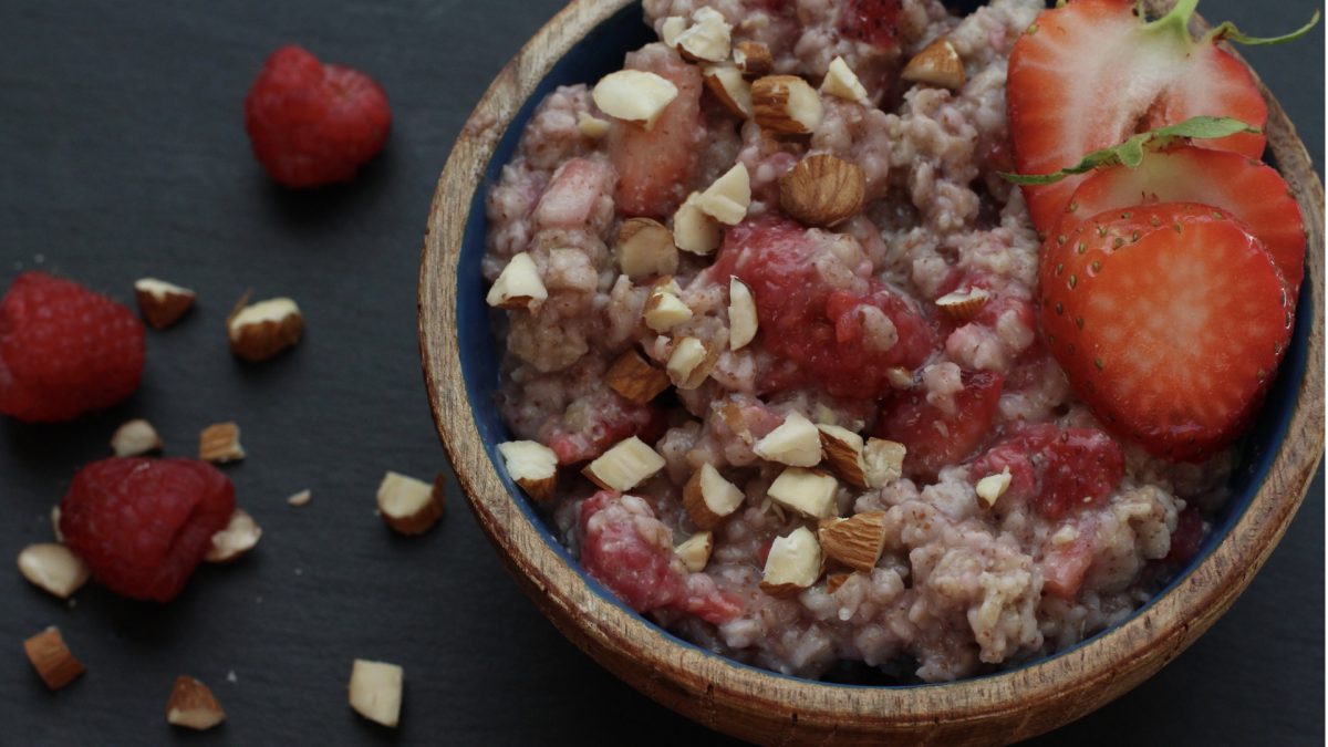 bowl of oatmeal topped with nuts and strawberries