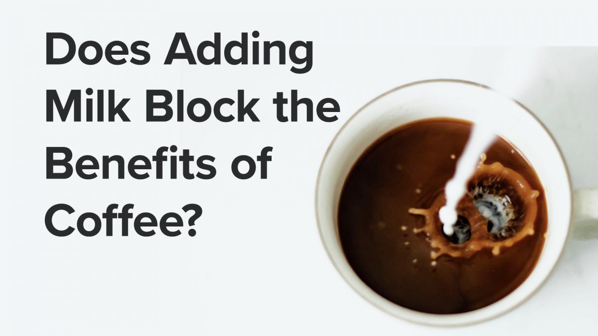 top-down view of milk pouring into a mug of coffee