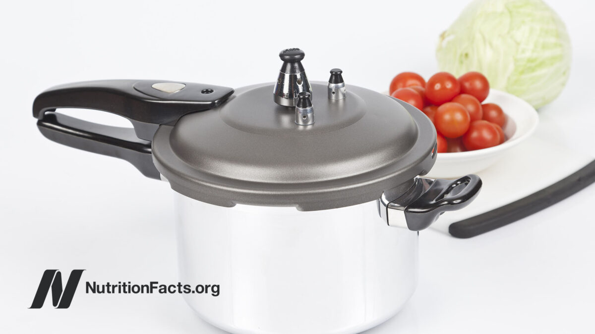 pressure cooker with tomatoes in background