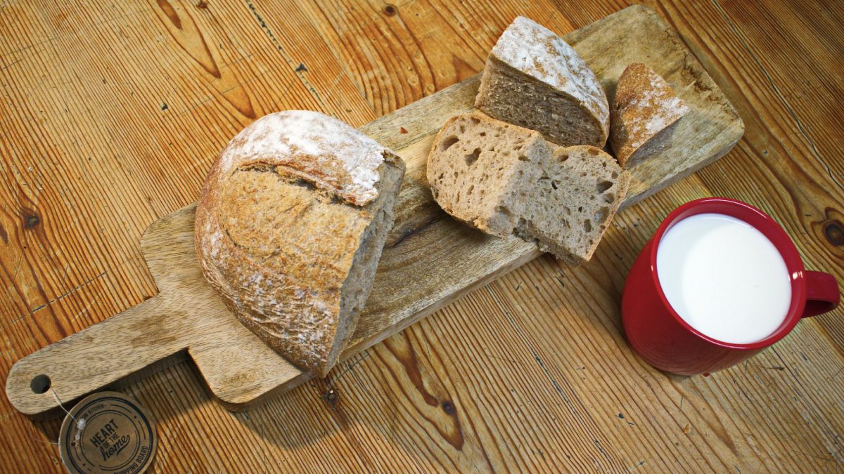 wooden board with cut up artisanal bread