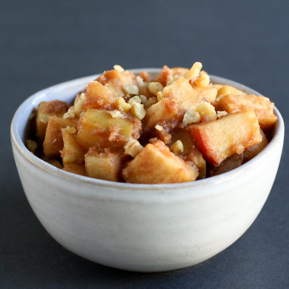 bowl of baked apple cubes and crushed nuts
