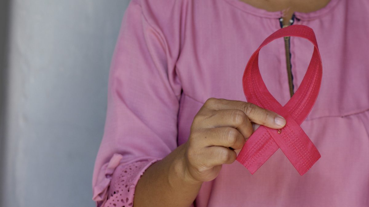woman holding a pink ribbon