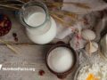 Milk, cottage cheese, sour cream and wheat on rustic wooden background