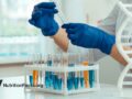 scientist considering test tubes