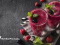 top view of berry smoothies on a dark countertop