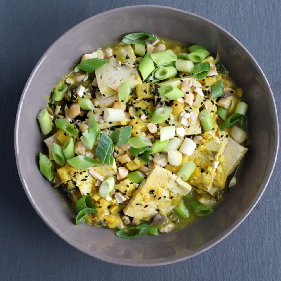 ceramic bowl filled with tofu and vegetable stir fry