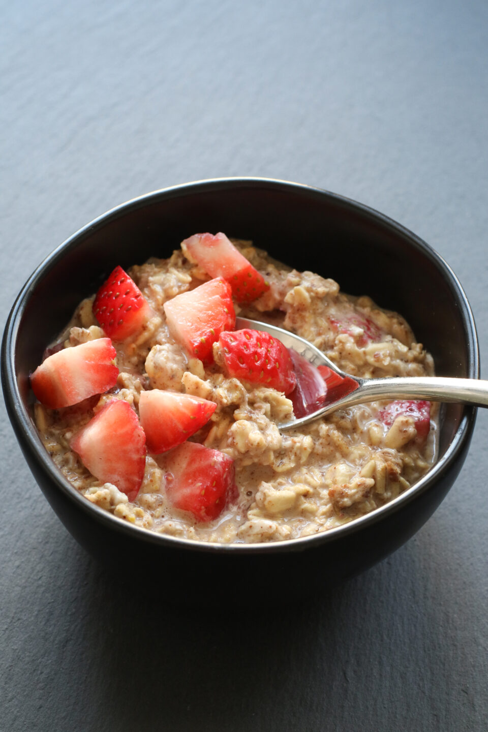bowl of overnight oats topped with strawberries