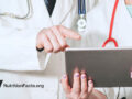two doctors discussing medical report on a tablet