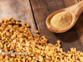fenugreek seeds and powder over wood surface