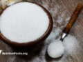 Bowl of sweetener on wooden countertop