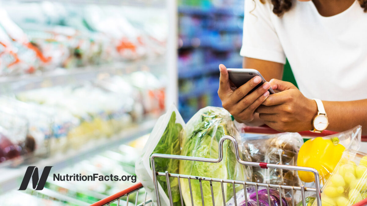 Woman with shopping cart with vegetables