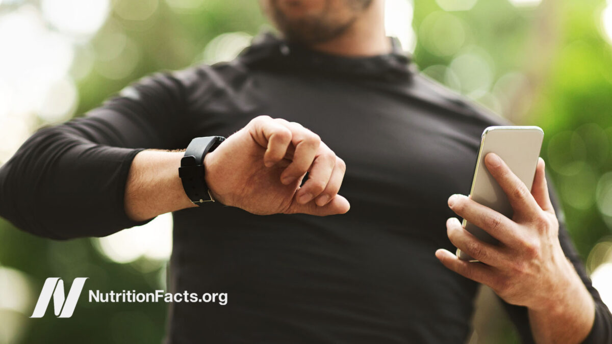 Man looking at smart watch outside