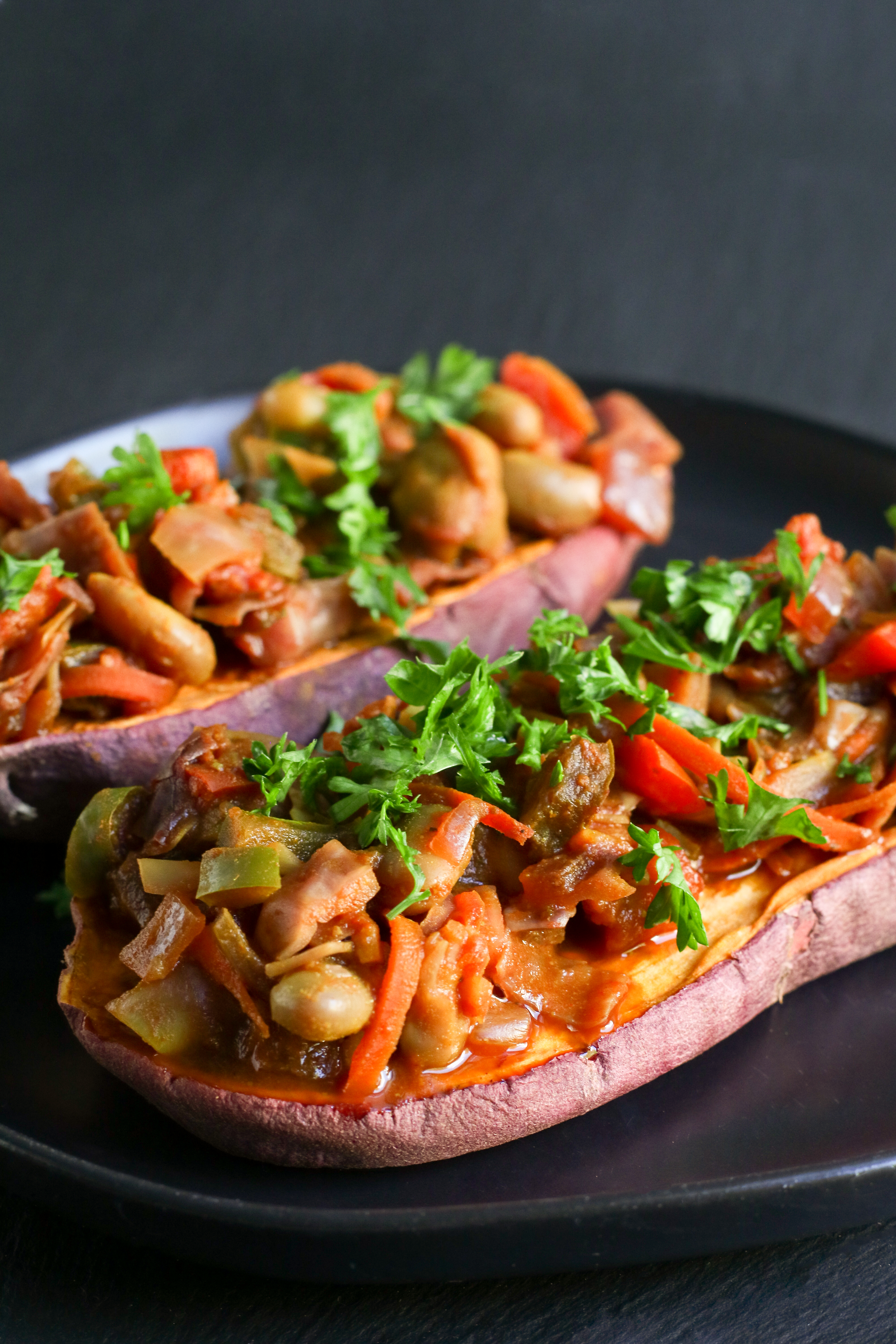 baked sweet potatoes topped with chakalaka and herbs