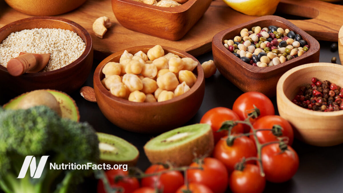 Assorted bowls with beans, tomato, and kiwi