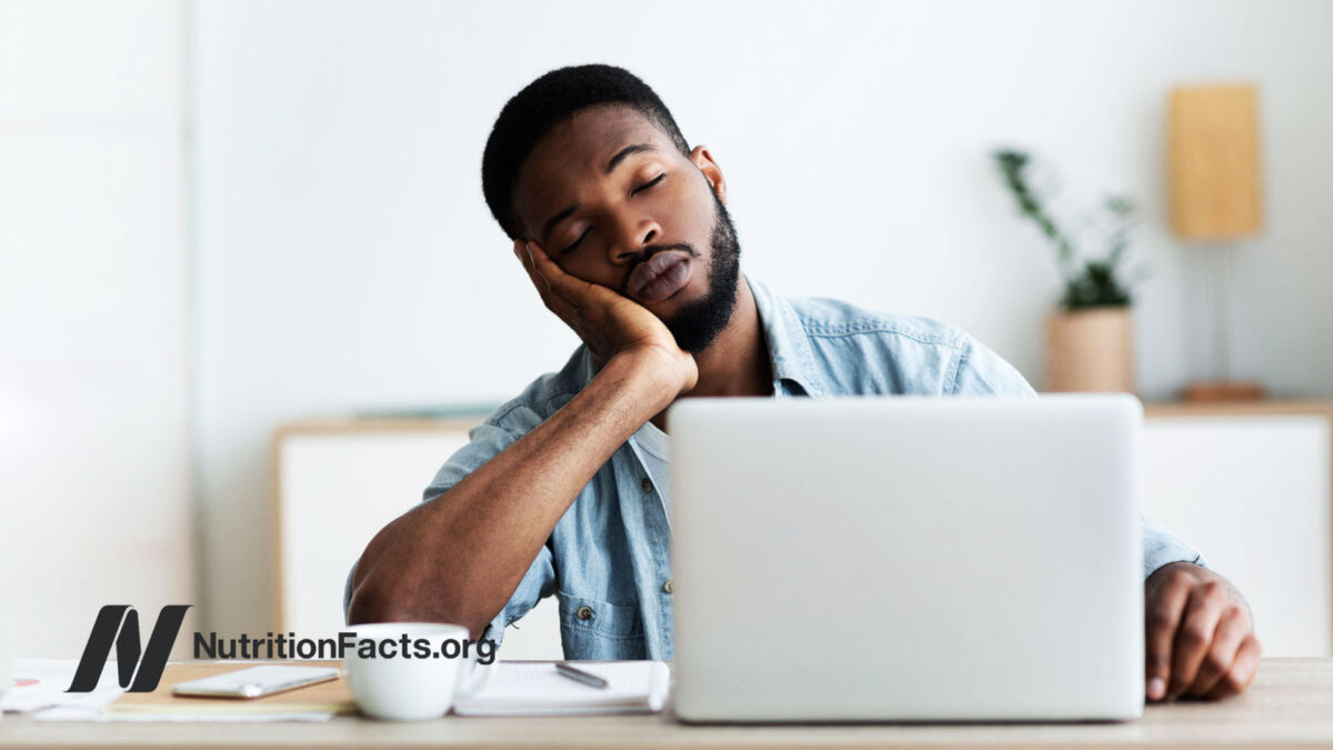 Man falling asleep at a laptop