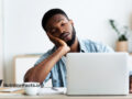 Man falling asleep at a laptop
