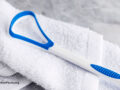 Tongue scraper on a white towel