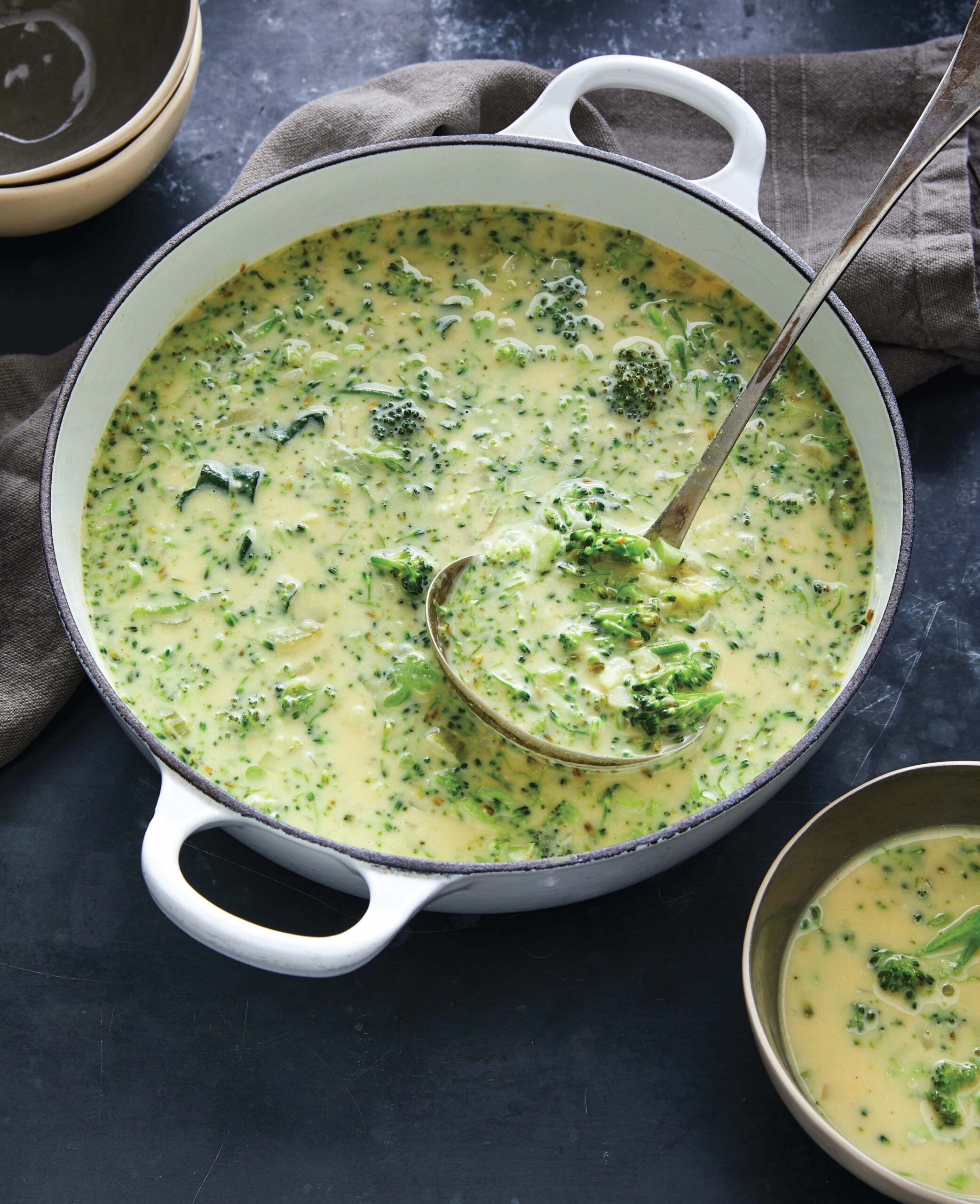 white pot filled with cheesy broccoli soup