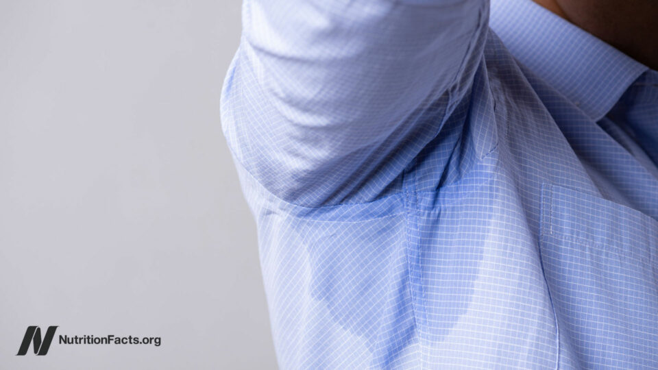 Person perspiring through button down shirt