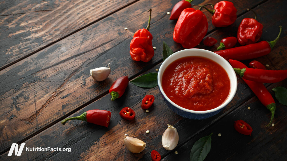 Spicy peppers on a dark wooden surface