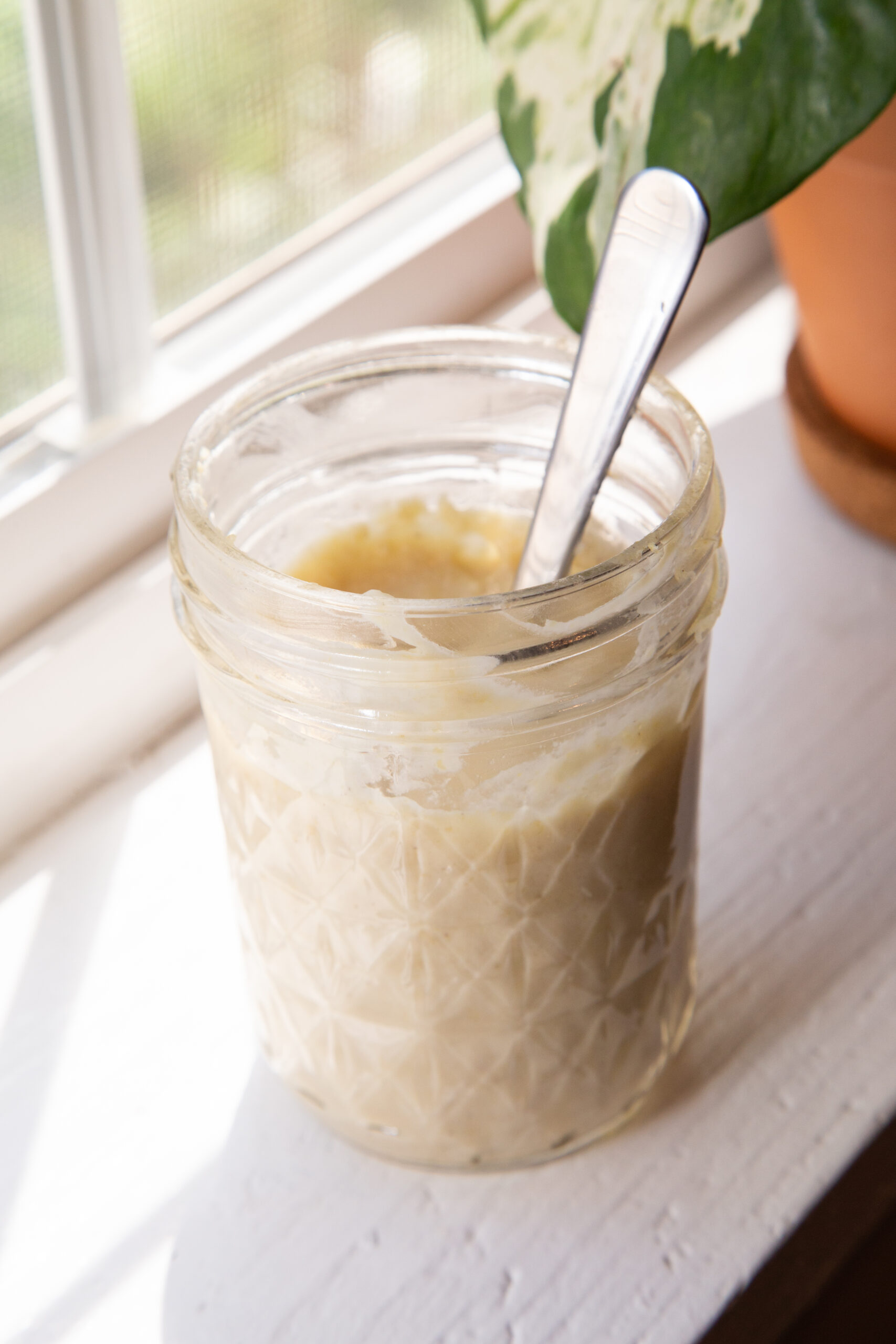 glass jar containing nut cheese spread