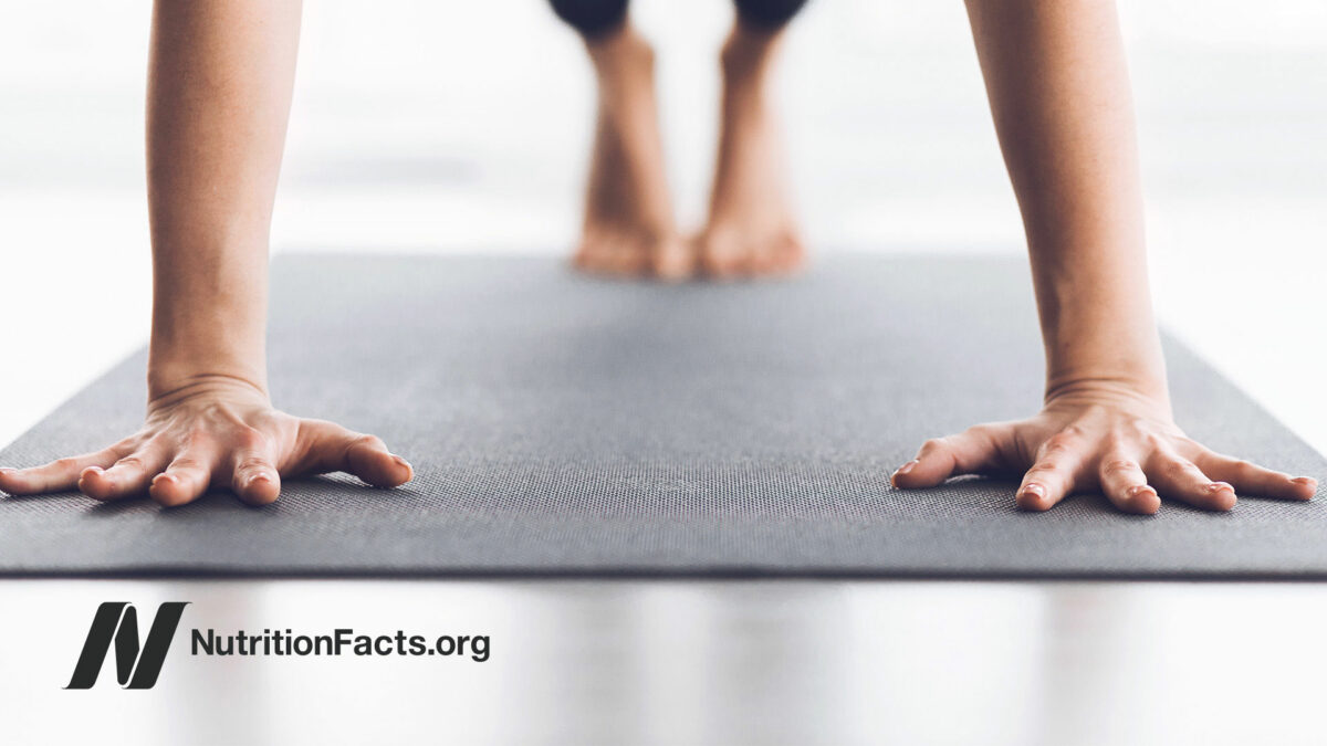 Rolling up a yoga mat in a classroom setting