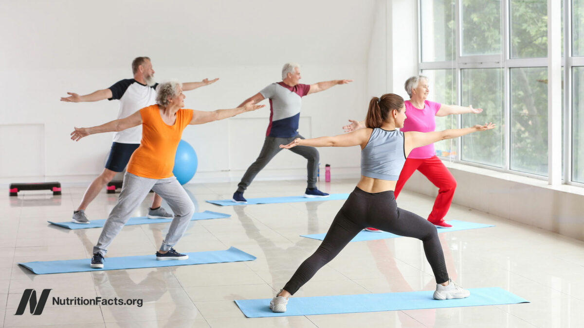 A group of people taking a yoga class