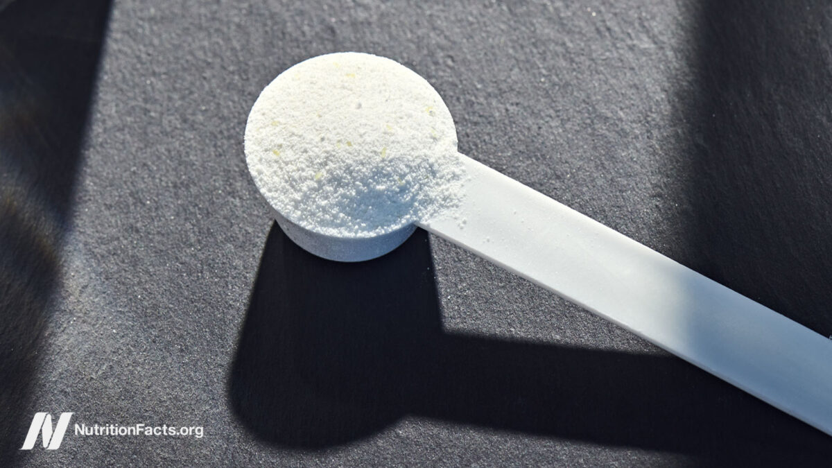 Creatine powder with natural beige background and props