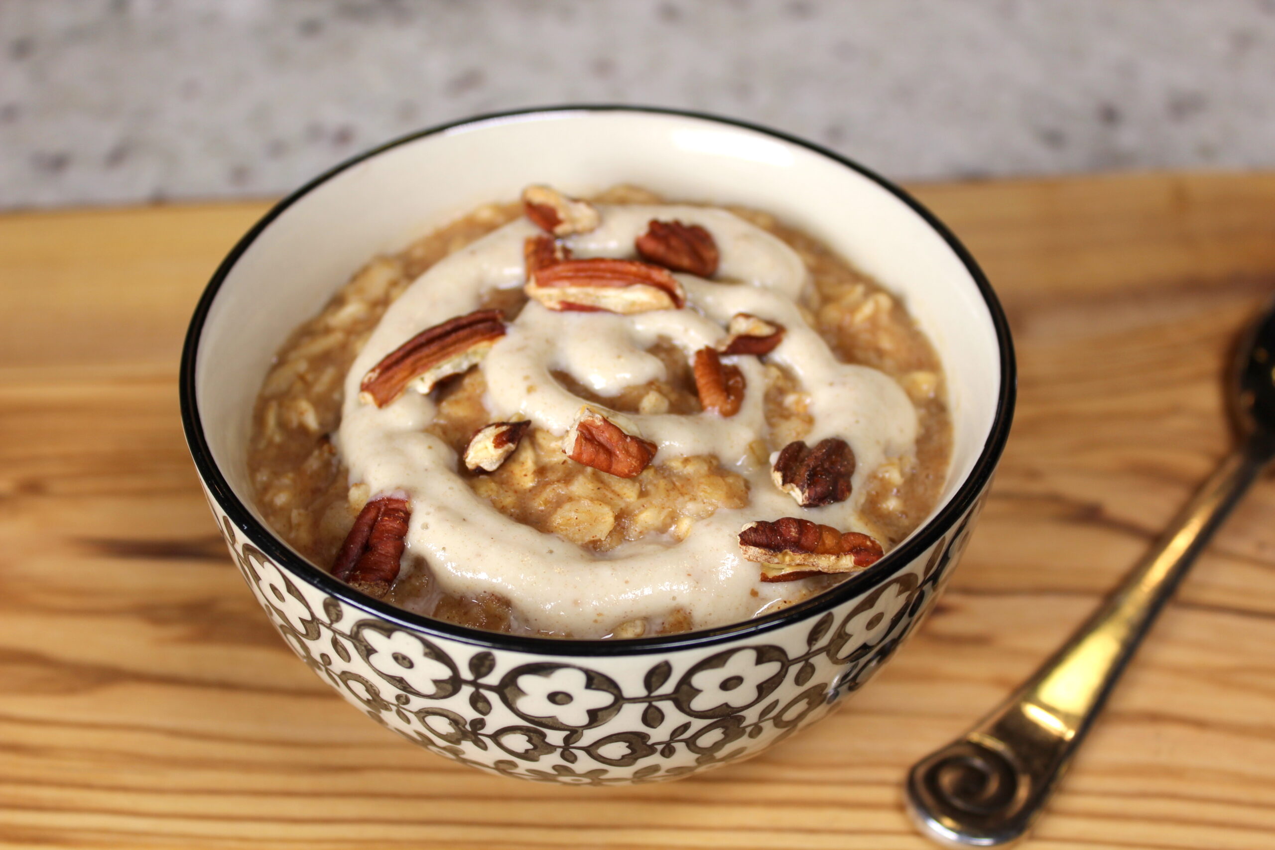 bowl of oatmeal topped with a drizzle and crushed nuts
