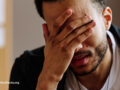Man touching face while suffering a stroke