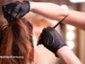 Stylist applying hair dye to client’s hair