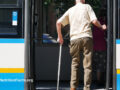 Old man getting on the bus