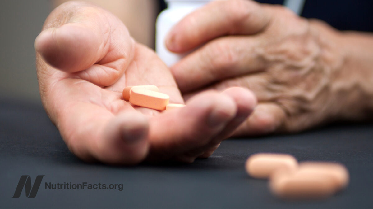 hands holding supplement pills