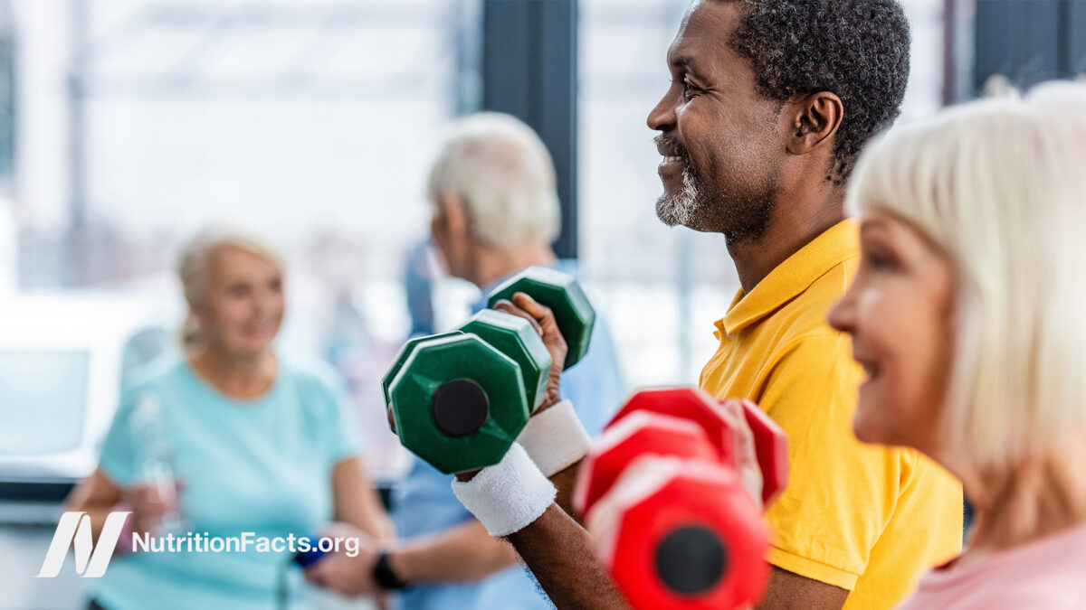 group of people lifting dumb bells