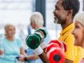 group of people lifting dumbbells