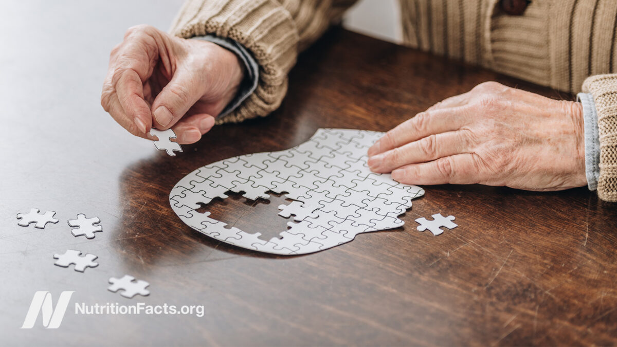 Person doing a puzzle of a human head