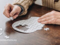 Person doing a puzzle of a human head