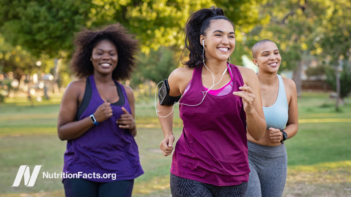Three happy women running outdoors