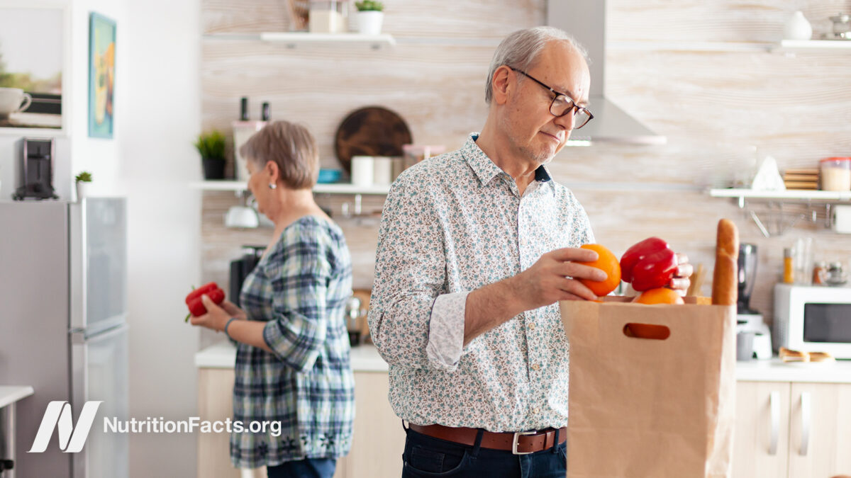 Older couple unpacking groceries