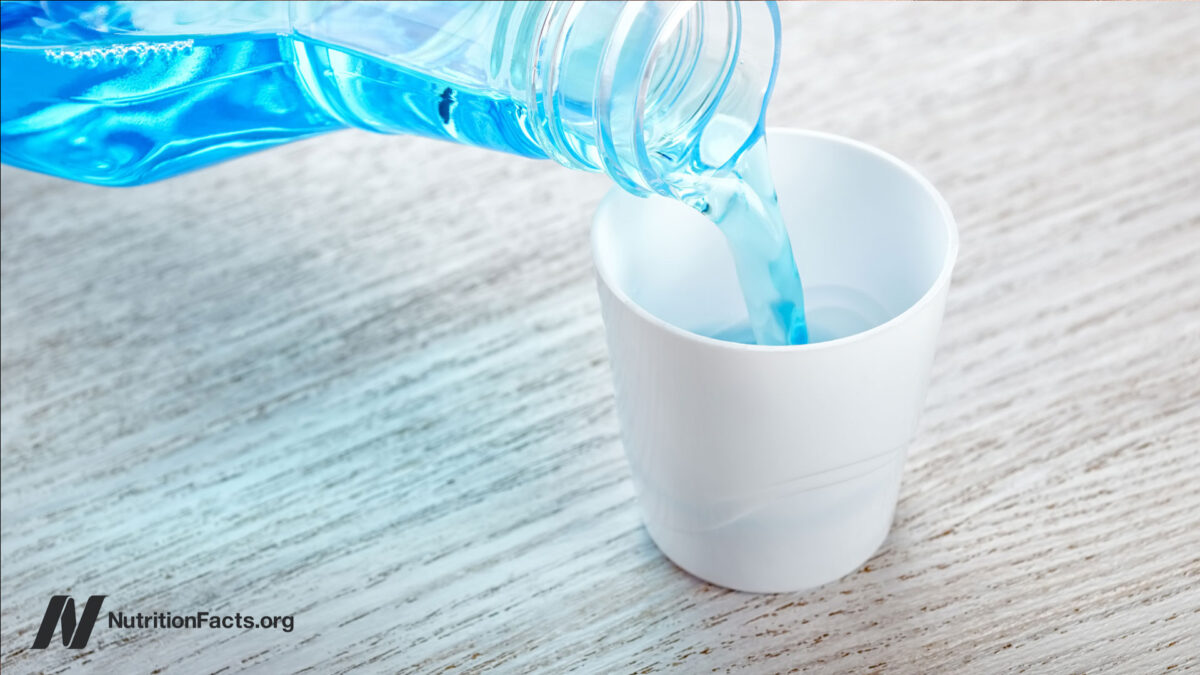 Mouthwash being poured into a small white cup