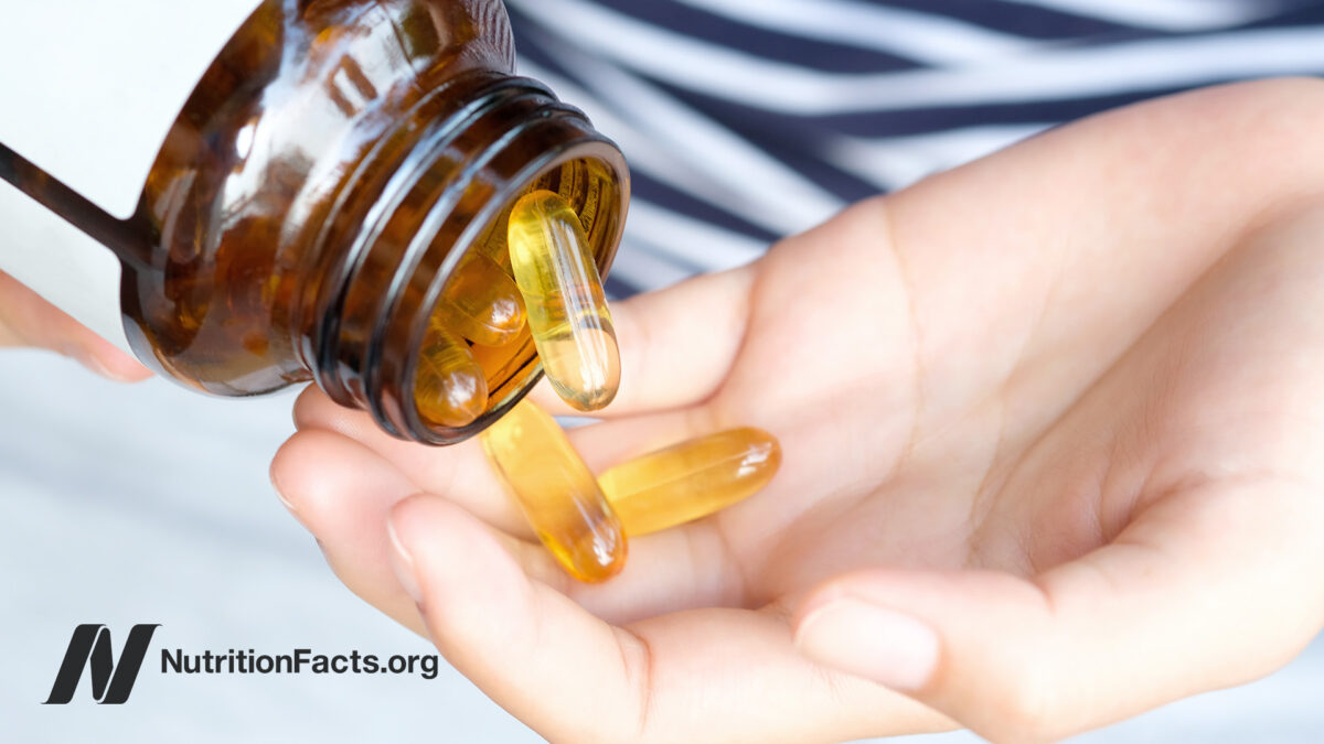 Liquid capsules from a bottle in a palm