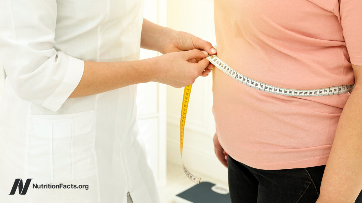 person getting their waist measured