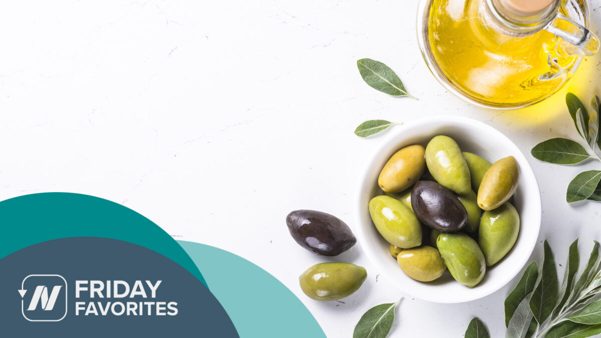 a bowl of olives and a bottle of olive oil