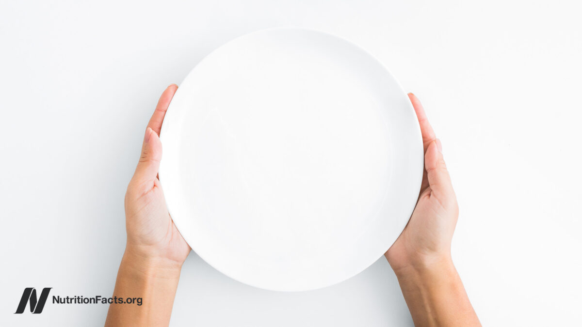 hands holding an empty plate